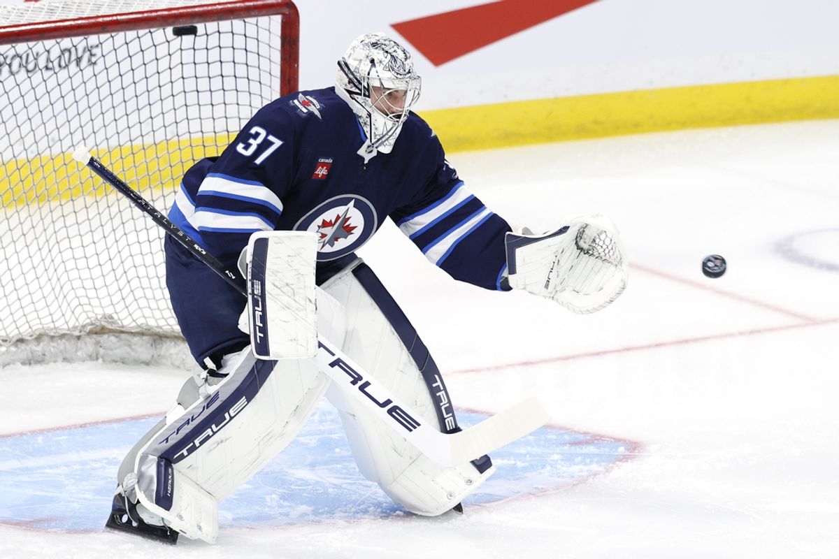 Nov 19, 2024; Winnipeg, Manitoba, CAN; Winnipeg Jets goaltender Connor Hellebuyck (37) warms up before a game against the Florida Panthers at Canada Life Centre. Mandatory Credit: James Carey Lauder-Imagn Images