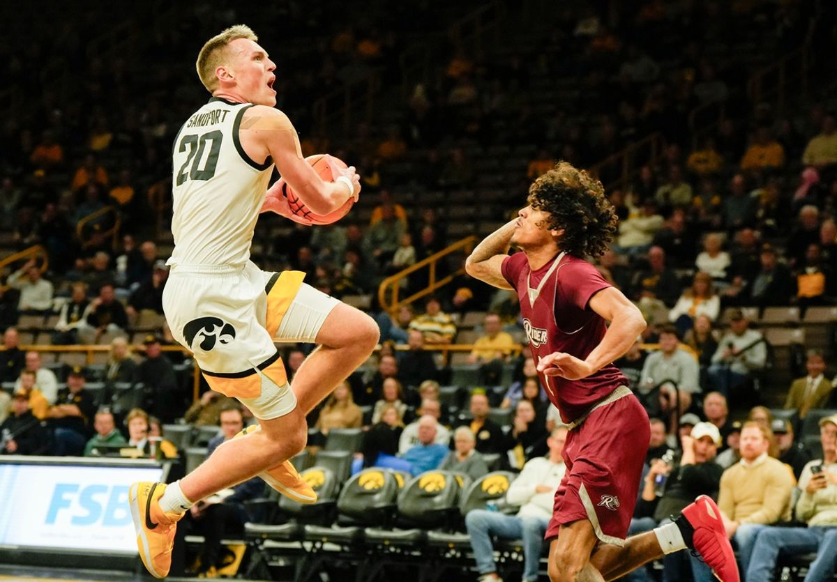 Iowa Hawkeyes forward Payton Sandfort (20) shoots as Rider Broncs guard Ruben Rodriguez (2) defends Tuesday, Nov. 19, 2024 at Carver-Hawkeye Arena in Iowa City, Iowa.