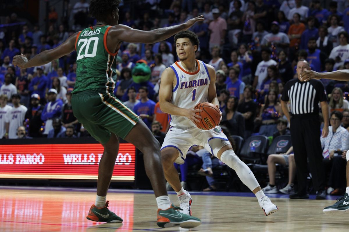 Nov 19, 2024; Gainesville, Florida, USA; Florida Gators guard Walter Clayton Jr. (1) handles the ball against Florida A&M Rattlers forward Jamine Charles (20) during the second half at Exactech Arena at the Stephen C. O'Connell Center. Mandatory Credit: Morgan Tencza-Imagn Images