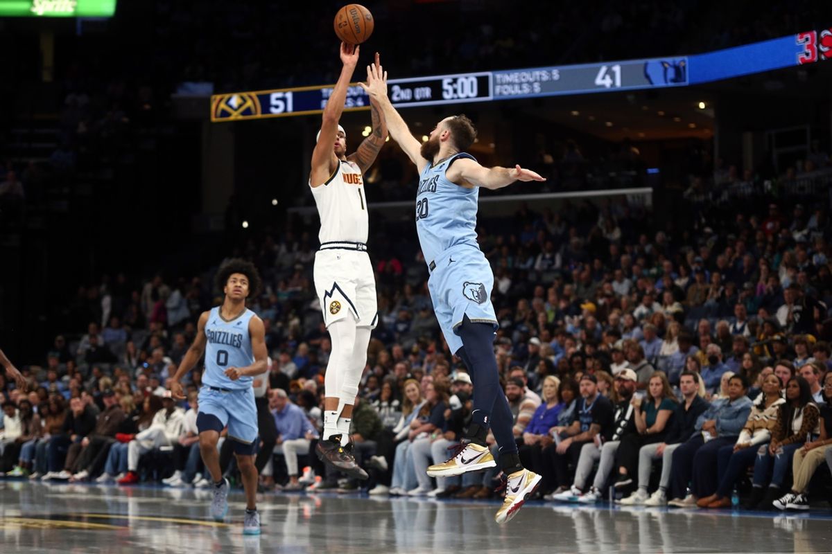 Nov 19, 2024; Memphis, Tennessee, USA; Denver Nuggets forward Michael Porter Jr. (1) shoots for three as Memphis Grizzlies center Jay Huff (30) defends at FedExForum. Mandatory Credit: Petre Thomas-Imagn Images