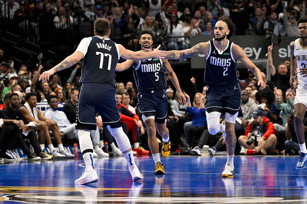 Nov 19, 2024; Dallas, Texas, USA; Dallas Mavericks guard Luka Doncic (77) and center Dereck Lively II (2) celebrate during the first half against the New Orleans Pelicans at the American Airlines Center. Mandatory Credit: Jerome Miron-Imagn Images