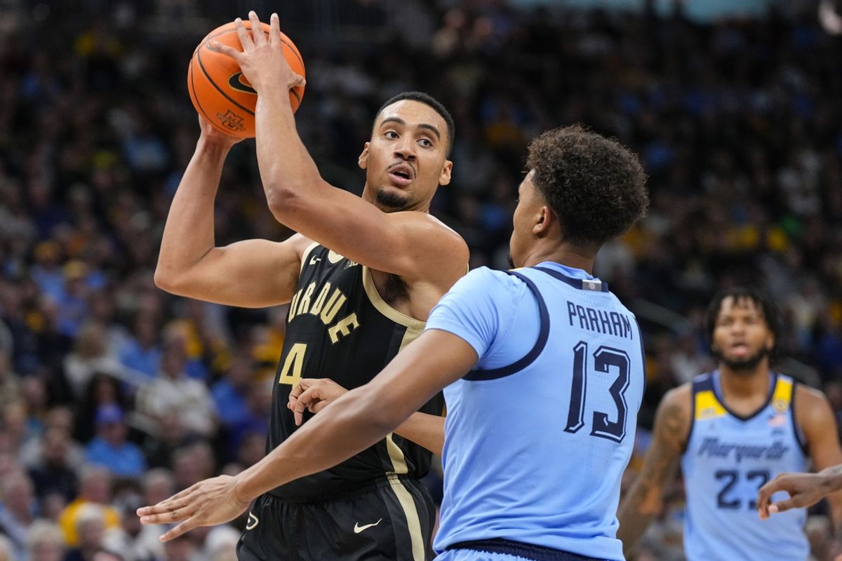 Nov 19, 2024; Milwaukee, Wisconsin, USA;  Purdue Boilermakers forward Trey Kaufman-Renn (4) looks to pass the ball as Marquette Golden Eagles forward Royce Parham (13) defends during the first half at Fiserv Forum. Mandatory Credit: Jeff Hanisch-Imagn Images