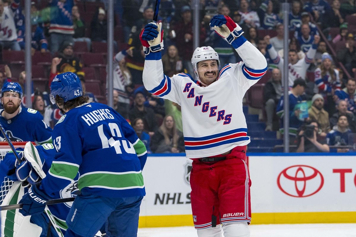 Nov 19, 2024; Vancouver, British Columbia, CAN; Vancouver Canucks defenseman Quinn Hughes (43) watches as New York Rangers forward Chris Kreider (20) celebrates a goal scored by forward Mika Zibanejad (93) during the first period at Rogers Arena. Mandatory Credit: Bob Frid-Imagn Images