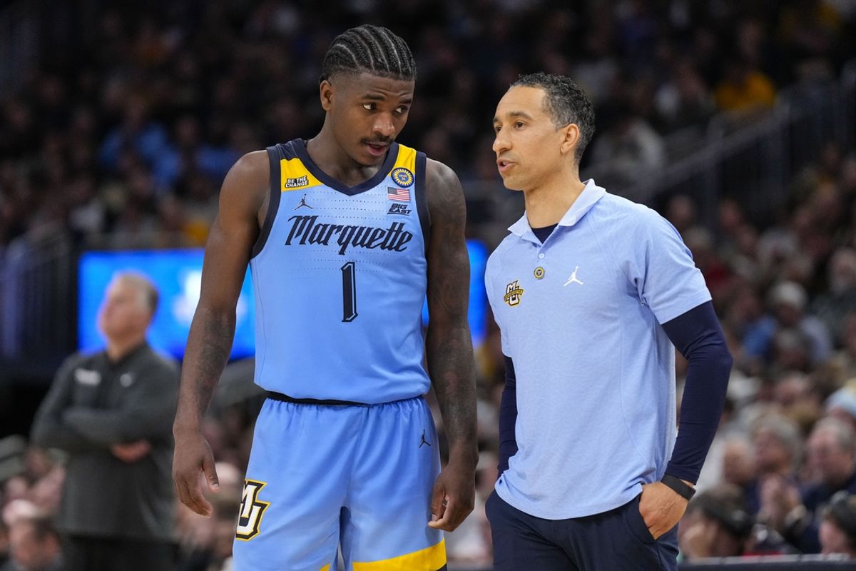 Nov 19, 2024; Milwaukee, Wisconsin, USA;  Marquette Golden Eagles head coach Shaka Smart talks with guard Kam Jones (1) during the second half against the Purdue Boilermakers at Fiserv Forum. Mandatory Credit: Jeff Hanisch-Imagn Images