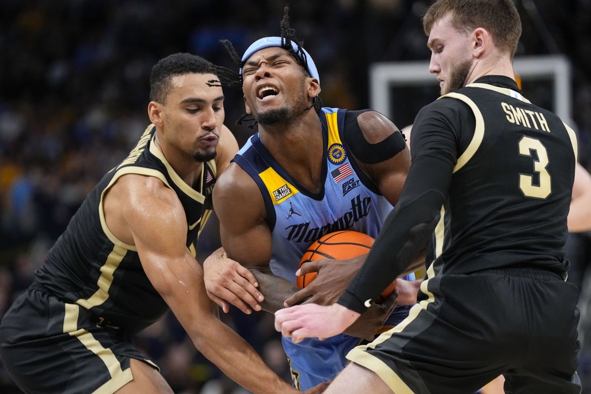 Nov 19, 2024; Milwaukee, Wisconsin, USA;  Marquette Golden Eagles guard Chase Ross (2) drives towards the basket between Purdue Boilermakers forward Trey Kaufman-Renn (4) and guard Braden Smith (3) during the second half at Fiserv Forum. Mandatory Credit: Jeff Hanisch-Imagn Images