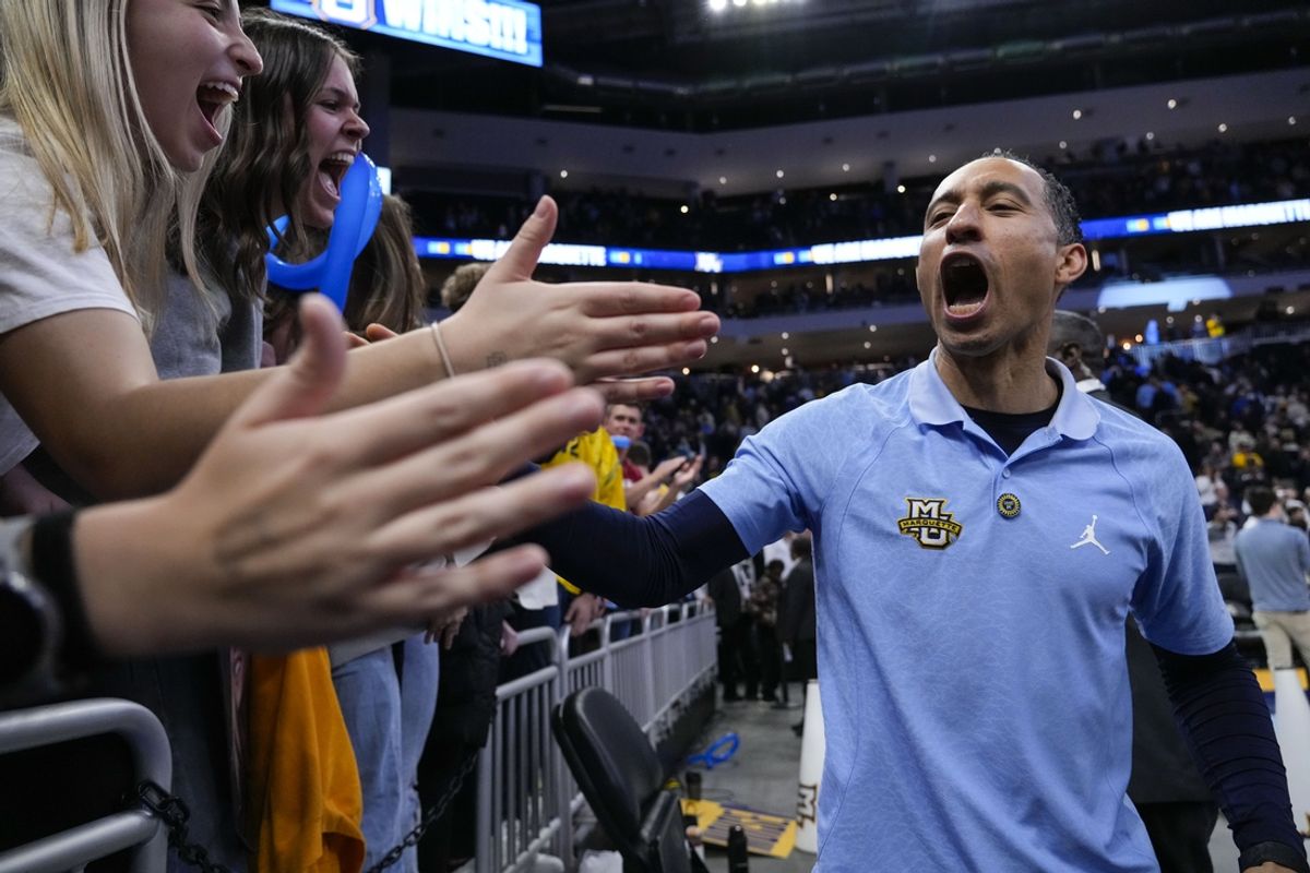 Nov 19, 2024; Milwaukee, Wisconsin, USA;  Marquette Golden Eagles head coach Shaka Smart celebrates with fans in the student section following the game against the Purdue Boilermakers at Fiserv Forum. Mandatory Credit: Jeff Hanisch-Imagn Images