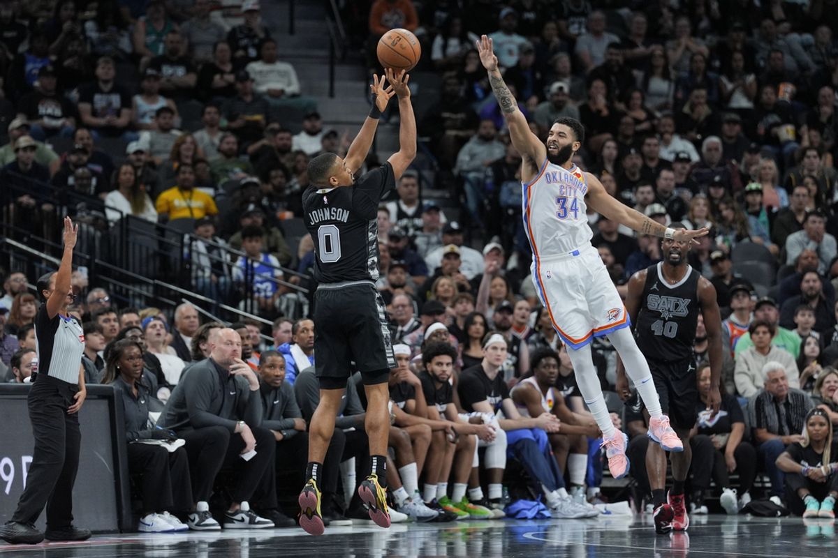 Nov 19, 2024; San Antonio, Texas, USA;  San Antonio Spurs forward Keldon Johnson (0) shoots in front of Oklahoma City Thunder forward Kenrich Williams (34) in the second half at Frost Bank Center. Mandatory Credit: Daniel Dunn-Imagn Images