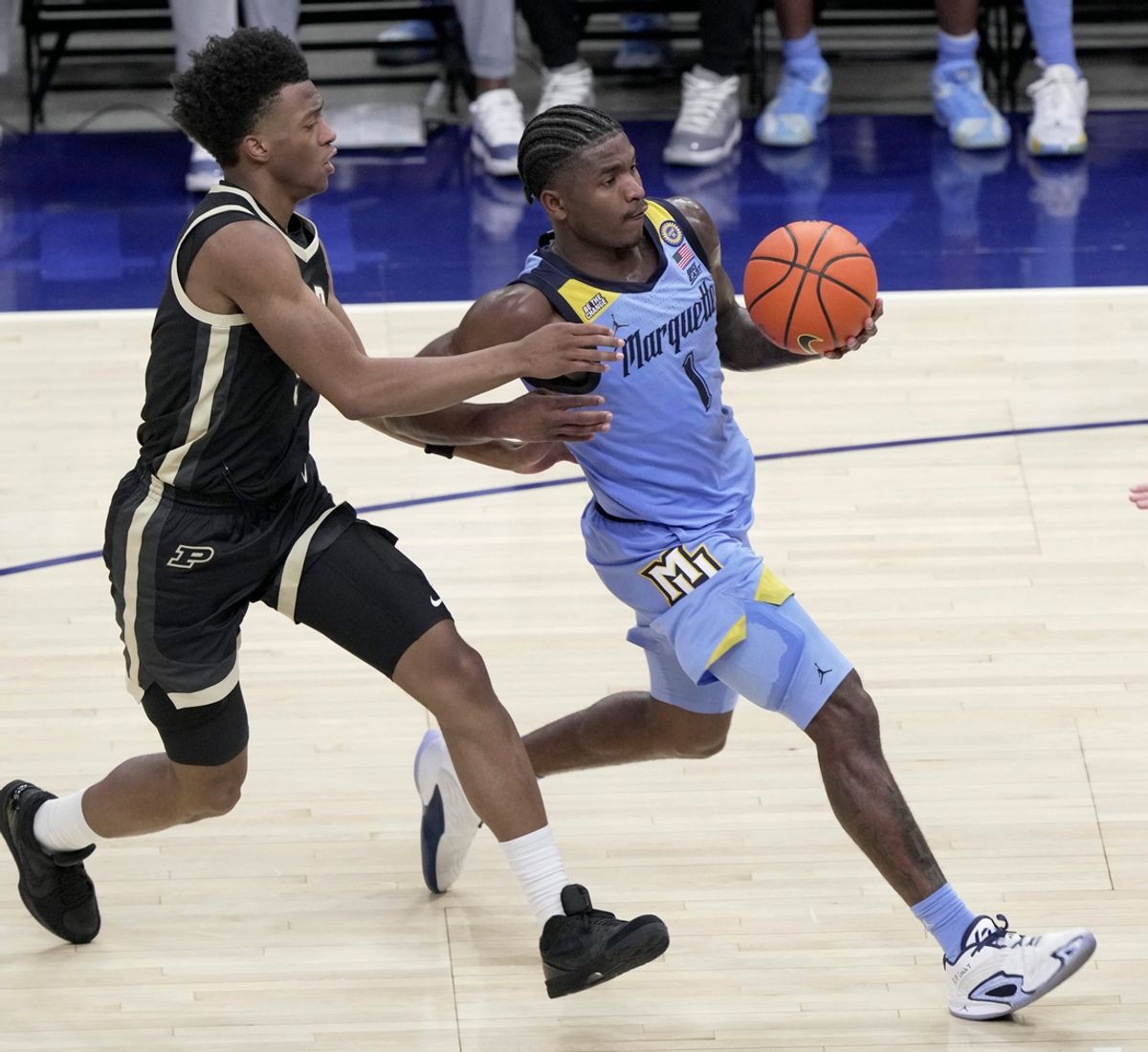 Marquette guard Kam Jones (1) drives past Purdue guard Myles Colvin (5) during the second half of their game Tuesday, November 19, 2024 at Fiserv Forum in Milwaukee, Wisconsin. Marquette beat Purdue 76-58.