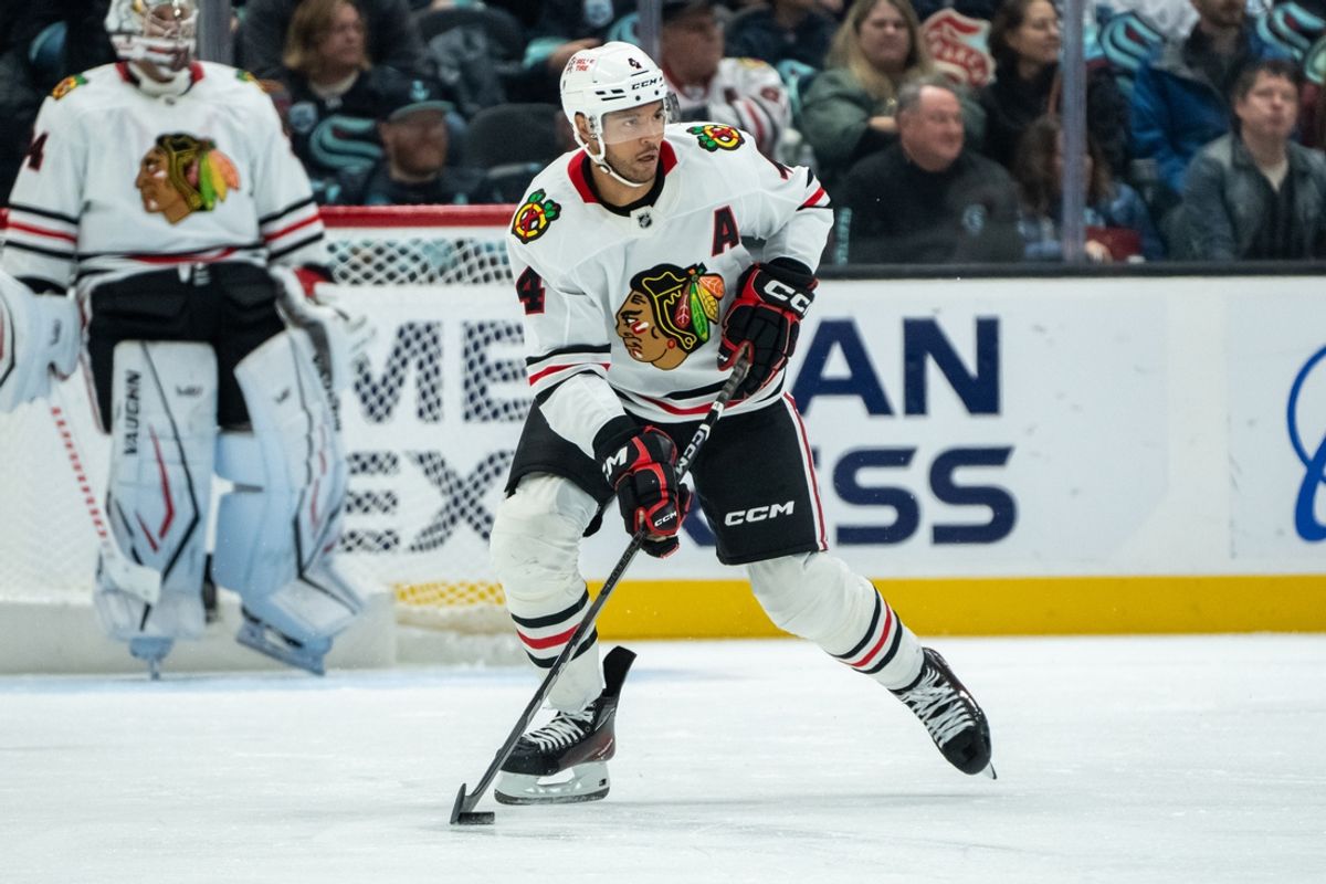 Nov 14, 2024; Seattle, Washington, USA;  Chicago Blackhawks defenseman Seth Jones (4) skates with the puck against the Seattle Kraken at Climate Pledge Arena. Mandatory Credit: Stephen Brashear-Imagn Images
