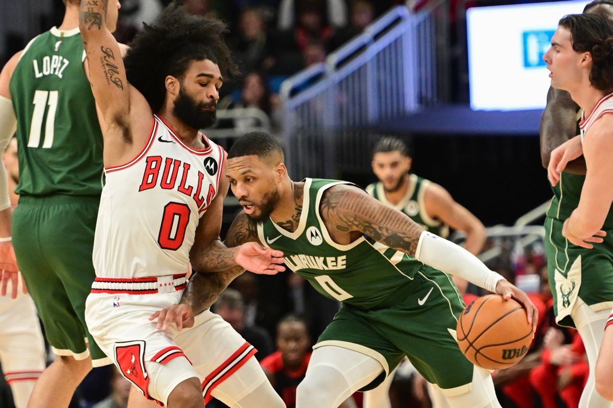 Nov 20, 2024; Milwaukee, Wisconsin, USA; Milwaukee Bucks guard Damian Lillard (0) drives for the basket against Chicago Bulls guard Coby White (0) in the first quarter at Fiserv Forum. Mandatory Credit: Benny Sieu-Imagn Images