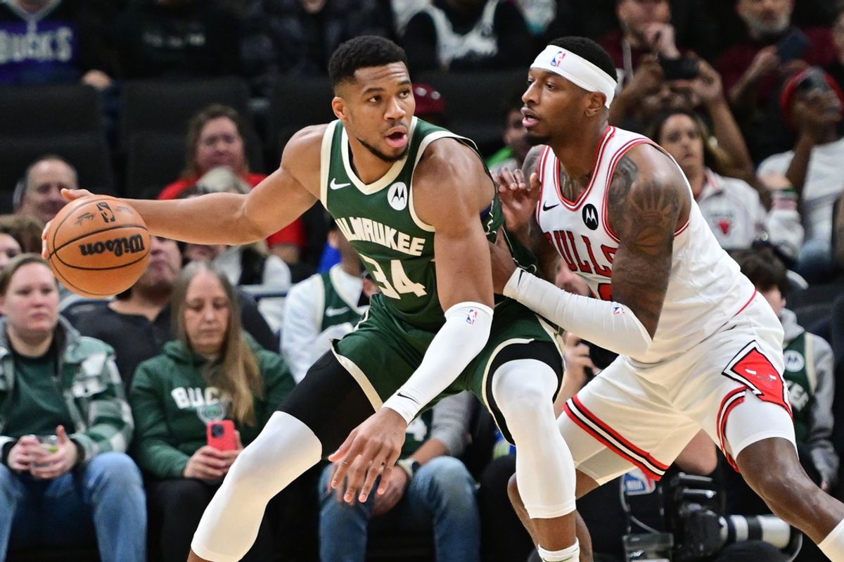 Nov 20, 2024; Milwaukee, Wisconsin, USA;  Milwaukee Bucks forward Giannis Antetokounmpo (34) is guarded by Chicago Bulls forward Torrey Craig (13) in the first quarter at Fiserv Forum. Mandatory Credit: Benny Sieu-Imagn Images