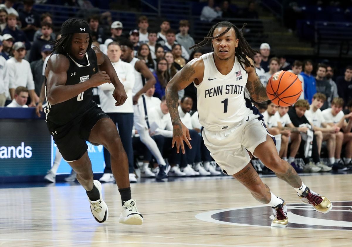 Nov 20, 2024; University Park, Pennsylvania, USA; Penn State Nittany Lions guard Ace Baldwin Jr (1) dribbles the ball around Purdue Fort Wayne Mastodons guard Rasheed Bello (0) during the first half at Bryce Jordan Center. Mandatory Credit: Matthew O'Haren-Imagn Images