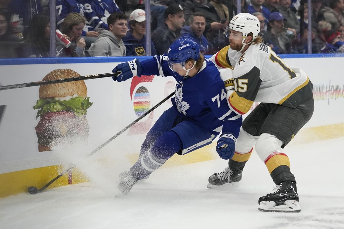 Nov 20, 2024; Toronto, Ontario, CAN; Toronto Maple Leafs forward Bobby McMann (74) and Vegas Golden Knights defenseman Noah Hanifin (15) battle for the puck during the first period at Scotiabank Arena. Mandatory Credit: John E. Sokolowski-Imagn Images