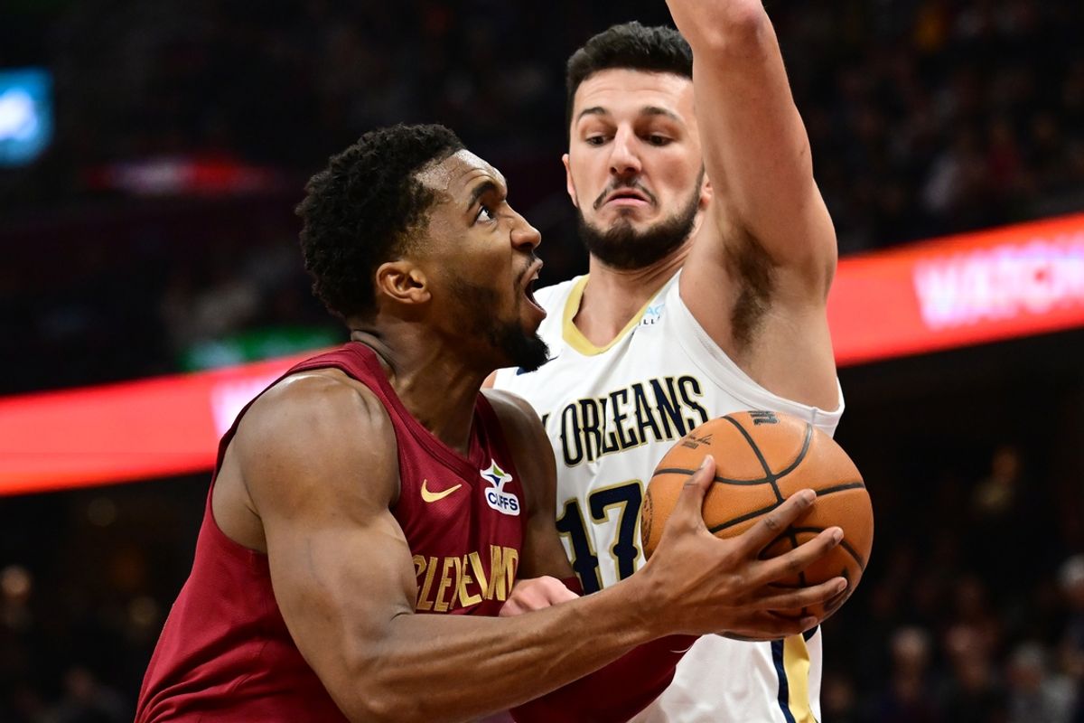 Nov 20, 2024; Cleveland, Ohio, USA; Cleveland Cavaliers guard Donovan Mitchell (45) drives to the basket against New Orleans Pelicans center Karlo Matkovic (17) during the first half at Rocket Mortgage FieldHouse. Mandatory Credit: Ken Blaze-Imagn Images