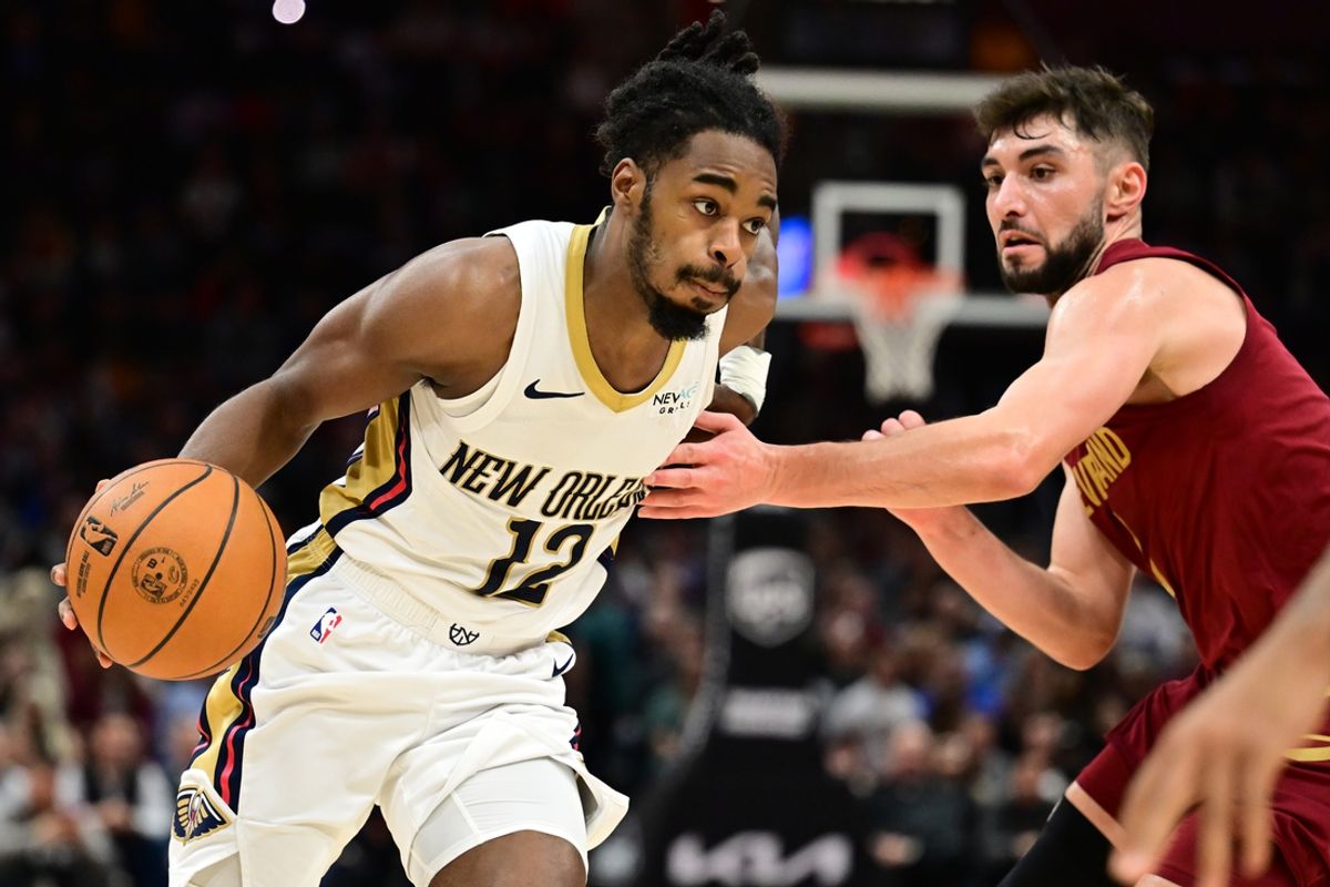 Nov 20, 2024; Cleveland, Ohio, USA; New Orleans Pelicans guard Antonio Reeves (12) drives to the basket against Cleveland Cavaliers guard Ty Jerome (2) during the second half at Rocket Mortgage FieldHouse. Mandatory Credit: Ken Blaze-Imagn Images