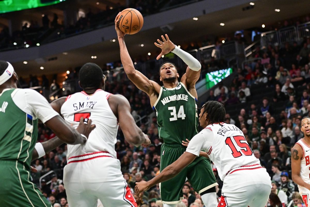 Nov 20, 2024; Milwaukee, Wisconsin, USA; Milwaukee Bucks forward Giannis Antetokounmpo (34) takes a shot against Chicago Bulls forward Jalen Smith (7) and forward Julian Phillips (15) in the third quarter at Fiserv Forum. Mandatory Credit: Benny Sieu-Imagn Images