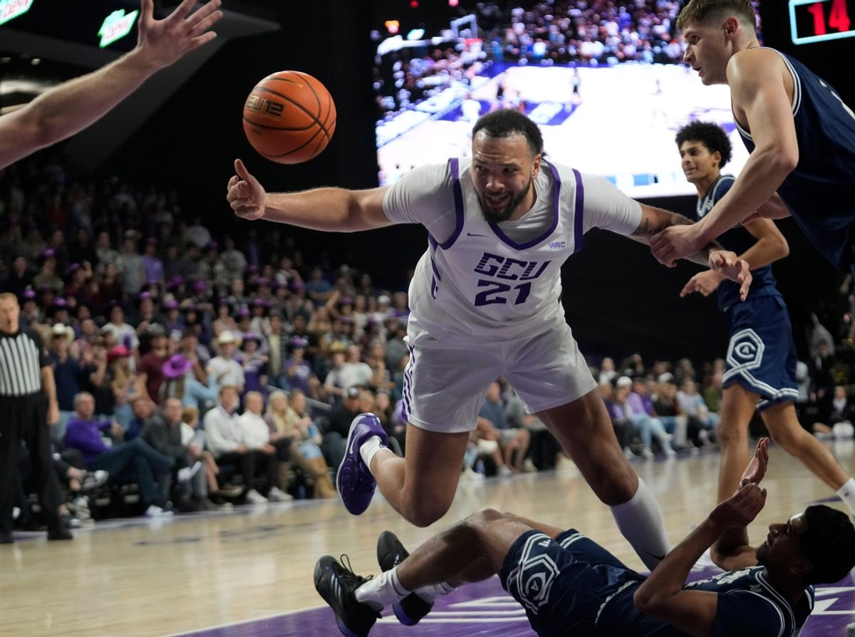Grand Canyon forward JaKobe Coles (21) is fouled by UC Davis Aggies guard Sione Lose (22) during the second half at Global Credit Union Arena in Phoenix on Nov. 20, 2024.