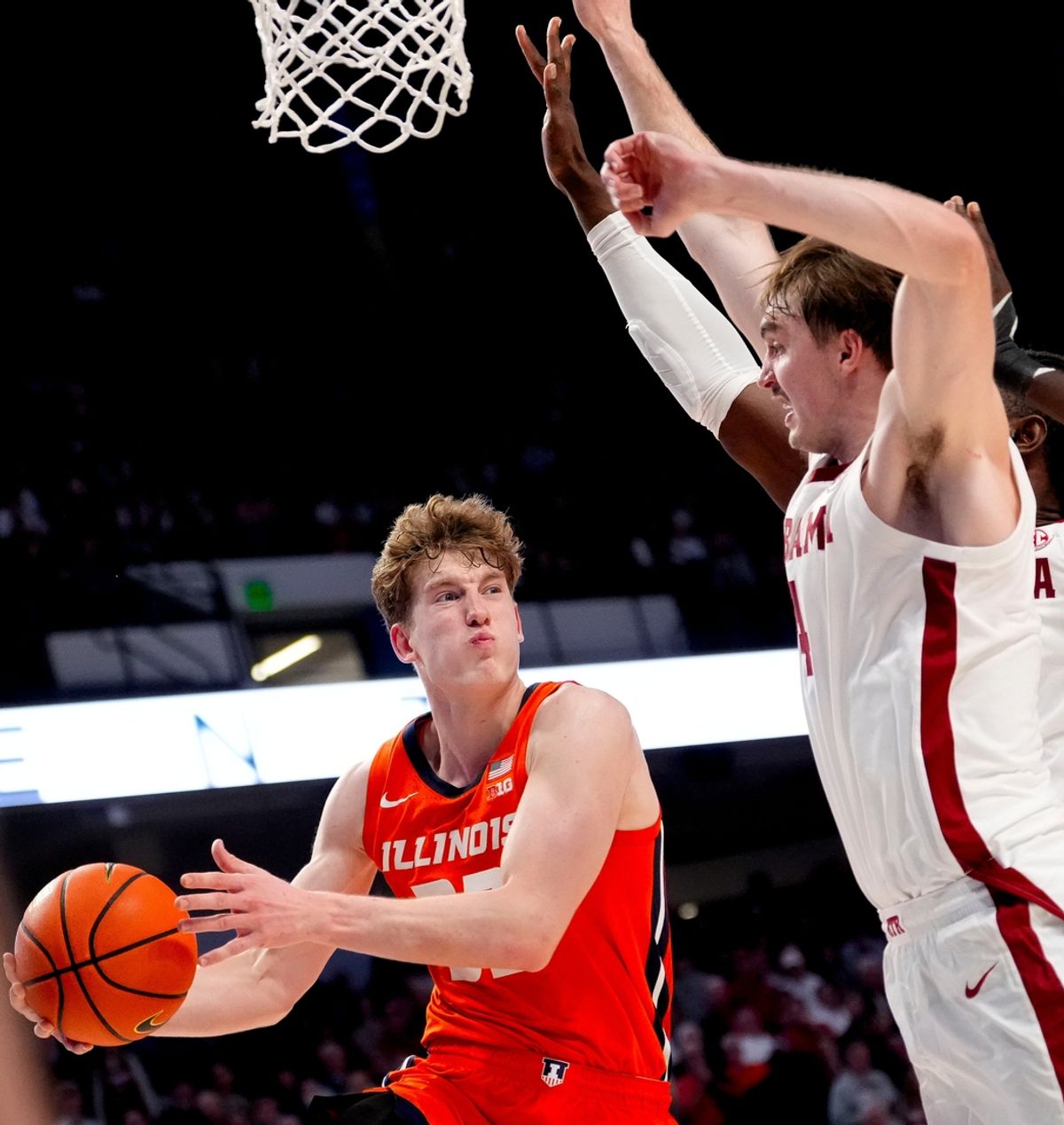 Nov 20, 2024; Birmingham, AL, USA; Illinois guard Kasparas Jakucionis (32) passes with Alabama forward Grant Nelson (4) defending in the CM Newton Classic at Legacy Arena. Alabama defeated Illinois 100-87. Mandatory Credit: Gary Cosby Jr.-Tuscaloosa News