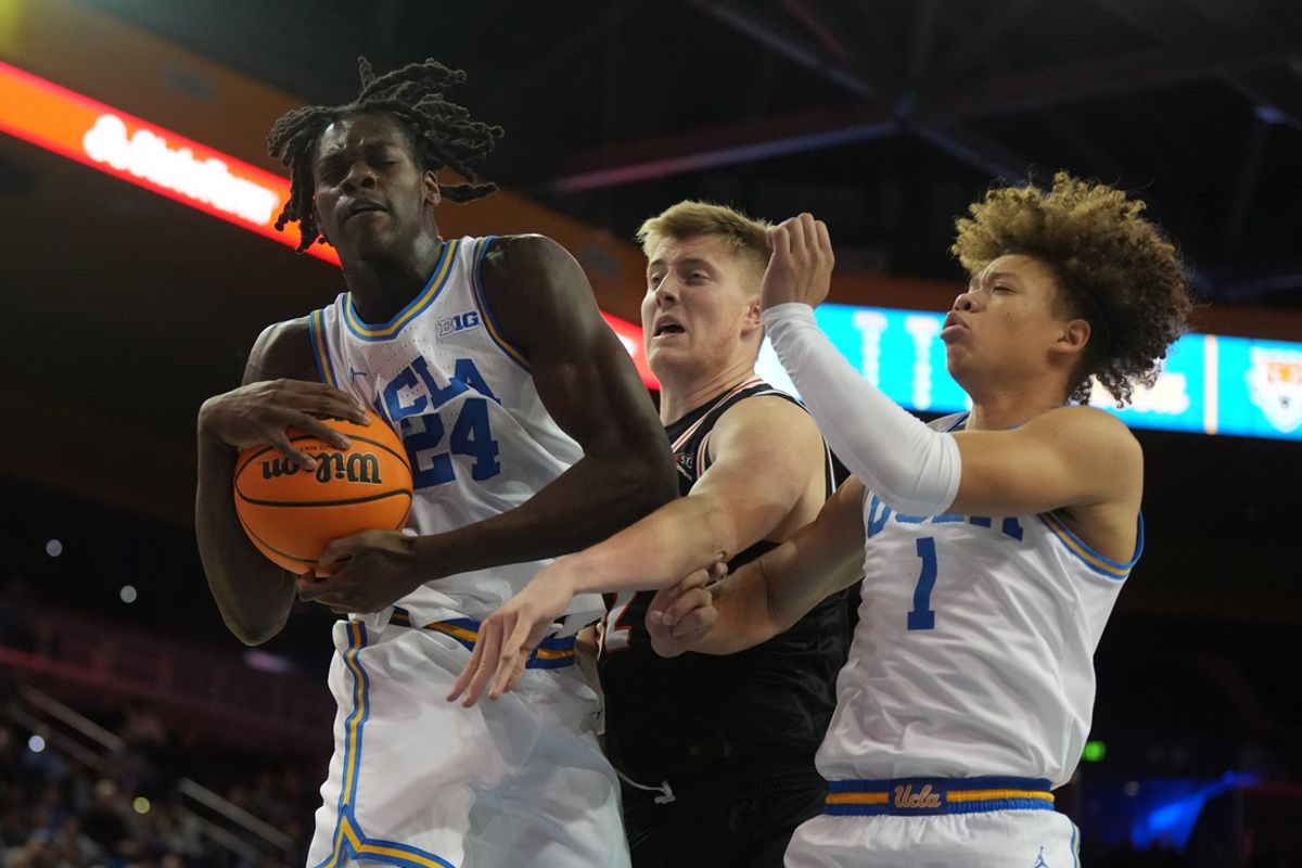 Nov 20, 2024; Los Angeles, California, USA; UCLA Bruins forward William Kyle III (24) and guard Trent Perry (1) battle for the ball with Idaho State Bengals forward Blake Daberkow (32) in the first half at Pauley Pavilion presented by Wescom. Mandatory Credit: Kirby Lee-Imagn Images