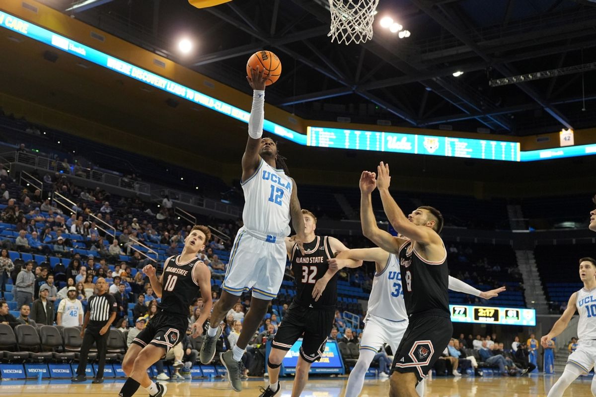 Nov 20, 2024; Los Angeles, California, USA; UCLA Bruins guard Sebastian Mack (12) shoots the ball against the Idaho State Bengals in the second half at Pauley Pavilion presented by Wescom. Mandatory Credit: Kirby Lee-Imagn Images