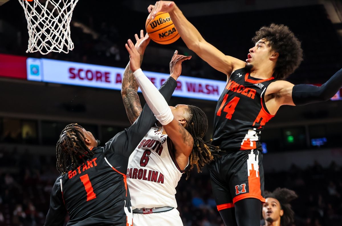 Nov 21, 2024; Columbia, South Carolina, USA; Mercer Bears forward TJ Grant (14) blocks the shot of South Carolina Gamecocks guard Jamarii Thomas (6) in the first half at Colonial Life Arena. Mandatory Credit: Jeff Blake-Imagn Images