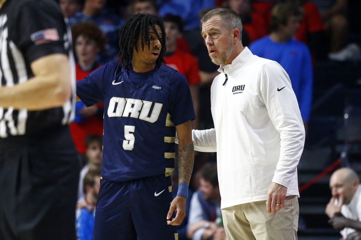 Nov 21, 2024; Oxford, Mississippi, USA; Oral Roberts Golden Eagles head coach Russell Springmann (right) talks with guard Darius Robinson Jr. (5) during the first half against the Mississippi Rebels at The Sandy and John Black Pavilion at Ole Miss. Mandatory Credit: Petre Thomas-Imagn Images