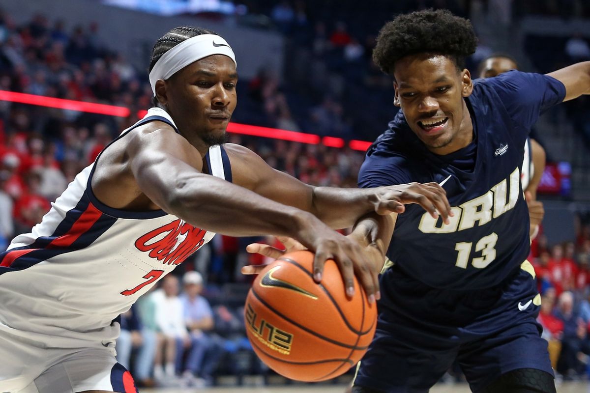Nov 21, 2024; Oxford, Mississippi, USA; Mississippi Rebels guard Davon Barnes (7) and Oral Roberts Golden Eagles forward Carlos Rosario (13) reach for a loose ball during the first half at The Sandy and John Black Pavilion at Ole Miss. Mandatory Credit: Petre Thomas-Imagn Images