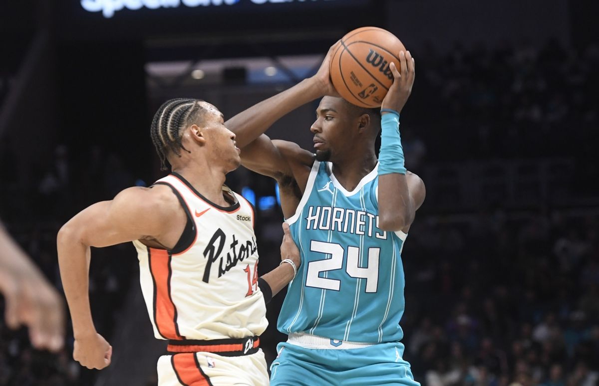 Nov 21, 2024; Charlotte, North Carolina, USA;  Charlotte Hornets forward Brandon Miller (24) looks to pass as he is defended by Detroit Pistons Wendell Moore Jr. (14) during the second half at the Spectrum Center. Mandatory Credit: Sam Sharpe-Imagn Images