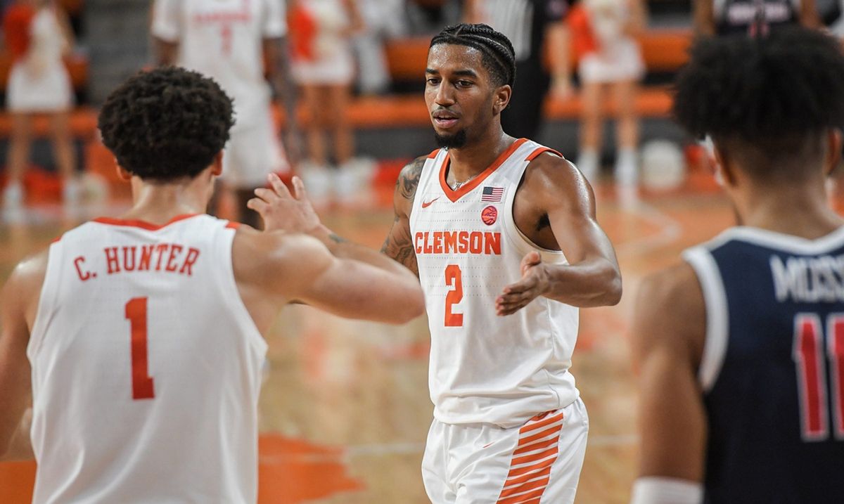 Clemson guard Dillon Hunter (2) is greeted by his brother Chase Hunter (1) during a timeout playing Radford, during the second half at Littlejohn Coliseum Thursday, November 21, 2024; Clemson, SC, USA.