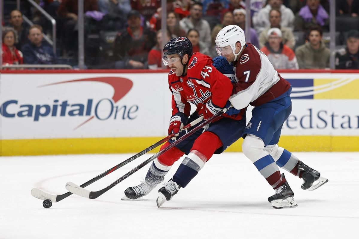 Nov 21, 2024; Washington, District of Columbia, USA; Washington Capitals right wing Tom Wilson (43) skates with the puck as Colorado Avalanche defenseman Devon Toews (7) defends in the third period at Capital One Arena. Mandatory Credit: Geoff Burke-Imagn Images