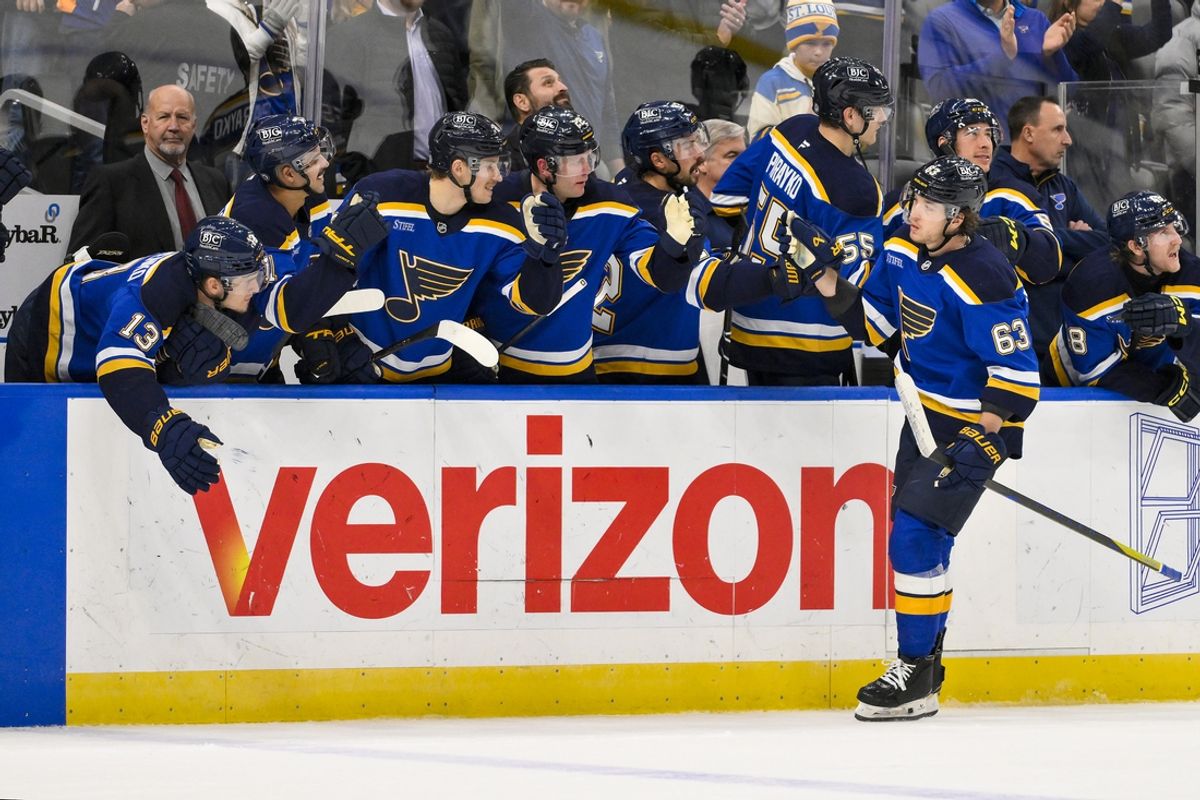 Nov 21, 2024; St. Louis, Missouri, USA;  St. Louis Blues left wing Jake Neighbours (63) is congratulated by teammates after scoring against San Jose Sharks goaltender Yaroslav Askarov (not pictured) in shootouts at Enterprise Center. Mandatory Credit: Jeff Curry-Imagn Images