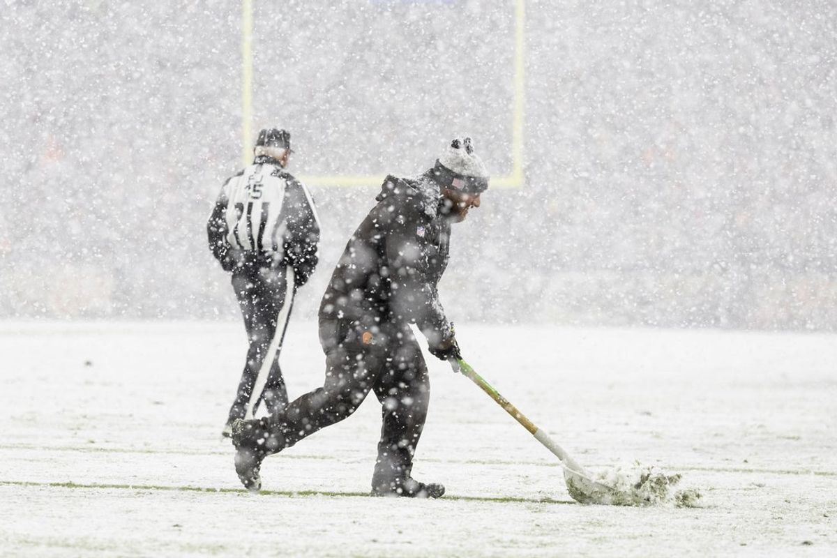 Nov 21, 2024; Cleveland, Ohio, USA; A grounds crew member shovels snow off the yard lines during the third quarter between the Cleveland Browns and the Pittsburgh Steelers at Huntington Bank Field Stadium. Mandatory Credit: Scott Galvin-Imagn Images