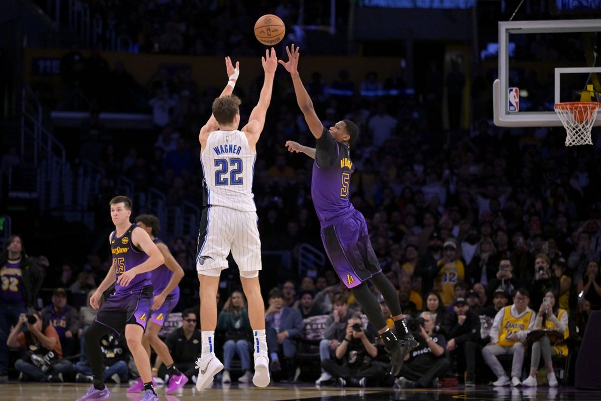 Nov 21, 2024; Los Angeles, California, USA; Orlando Magic forward Franz Wagner (22) hits a 3-point basket over Los Angeles Lakers forward Cam Reddish (5) with 2.5 seconds left in the game at Crypto.com Arena. Mandatory Credit: Jayne Kamin-Oncea-Imagn Images