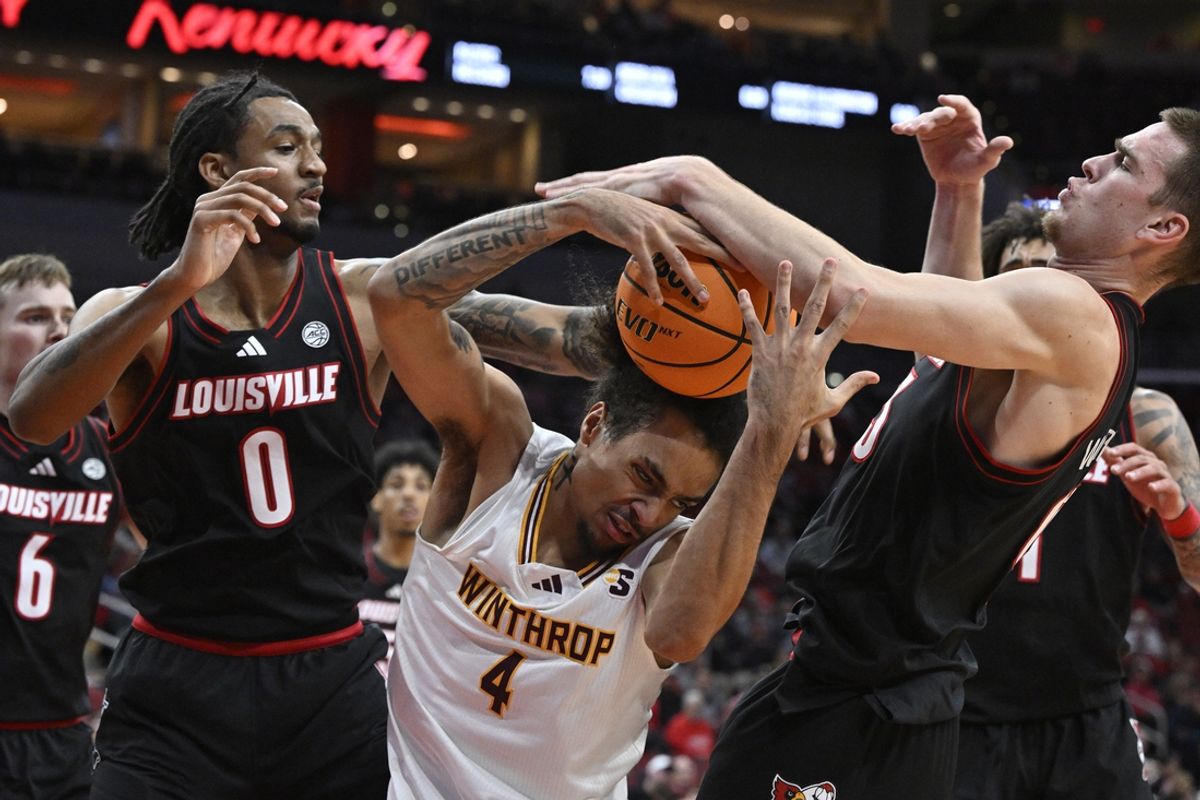 Nov 22, 2024; Louisville, Kentucky, USA;  Louisville Cardinals forward James Scott (0) and forward Noah Waterman (93) battle Winthrop Eagles forward Kelton Talford (4) for a rebound during the first half at KFC Yum! Center. Mandatory Credit: Jamie Rhodes-Imagn Images