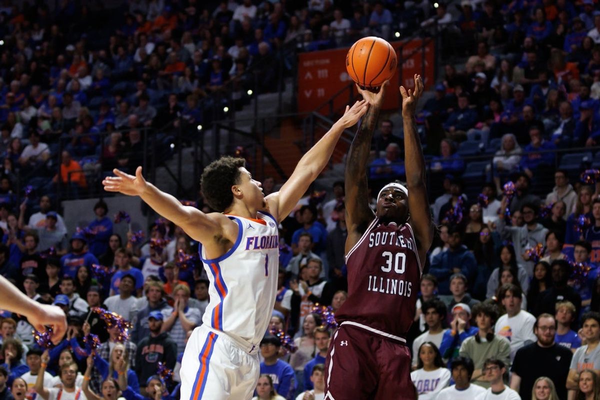 Nov 22, 2024; Gainesville, Florida, USA; Southern Illinois Salukis guard Kennard Davis Jr. (30) shoots over Florida Gators guard Walter Clayton Jr. (1) during the first half at Exactech Arena at the Stephen C. O'Connell Center. Mandatory Credit: Matt Pendleton-Imagn Images