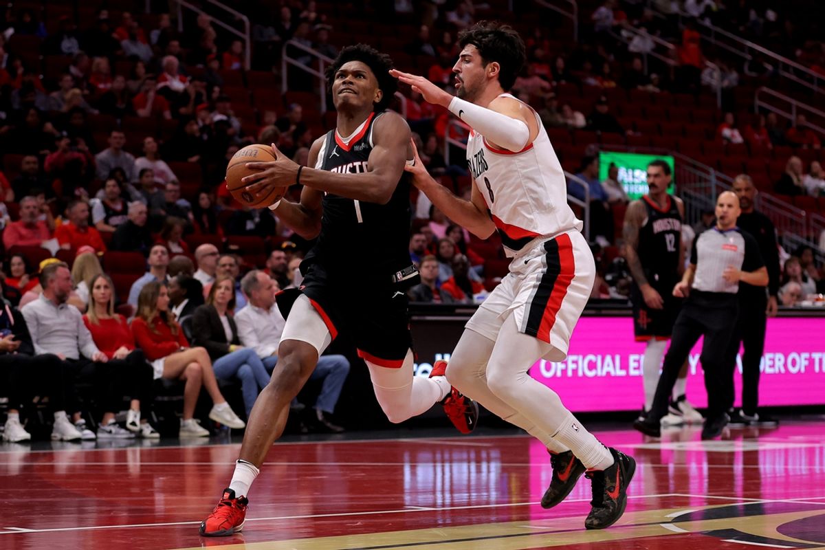 Nov 22, 2024; Houston, Texas, USA; Houston Rockets guard Amen Thompson (1) drives to the basket against Portland Trail Blazers forward Deni Avdija (8) during the first quarter at Toyota Center. Mandatory Credit: Erik Williams-Imagn Images
