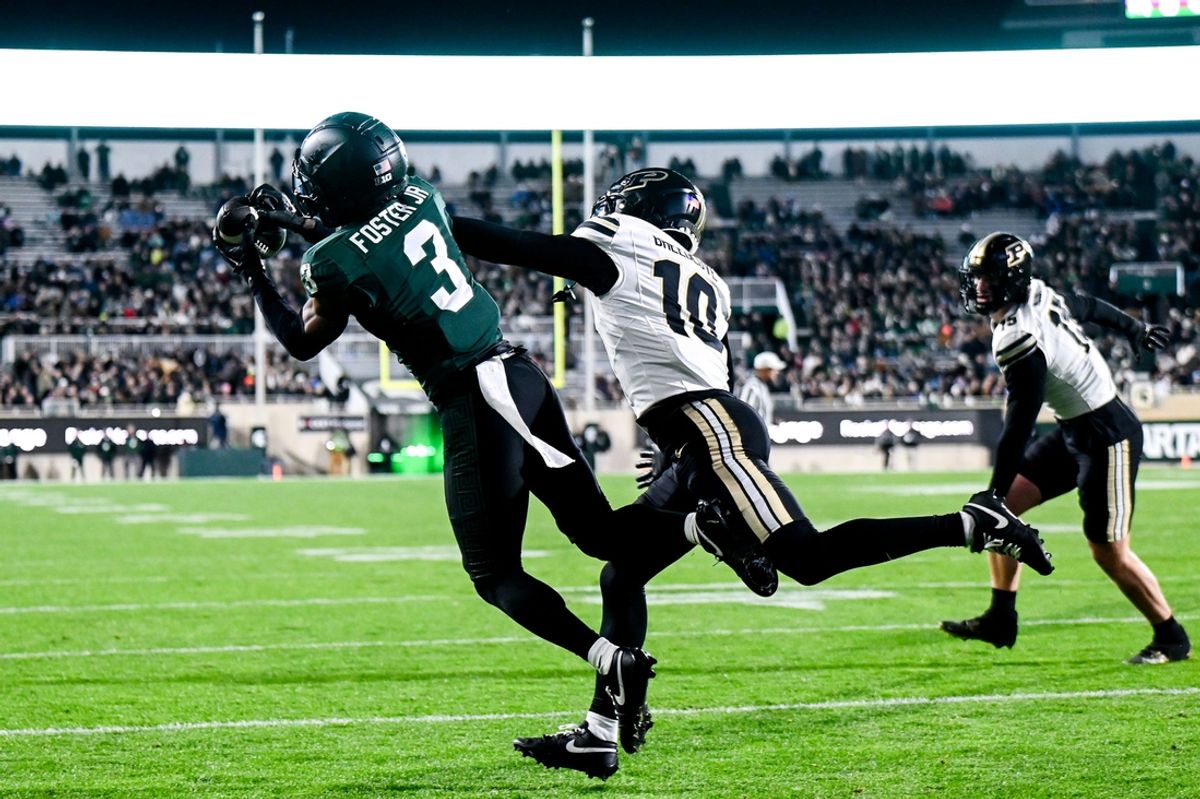 Michigan State's Montorie Foster Jr., left, catches a touchdown as Purdue's Kyndrich Breedlove defends during the first quarter on Friday, Nov. 22, 2024, at Spartan Stadium in East Lansing.
