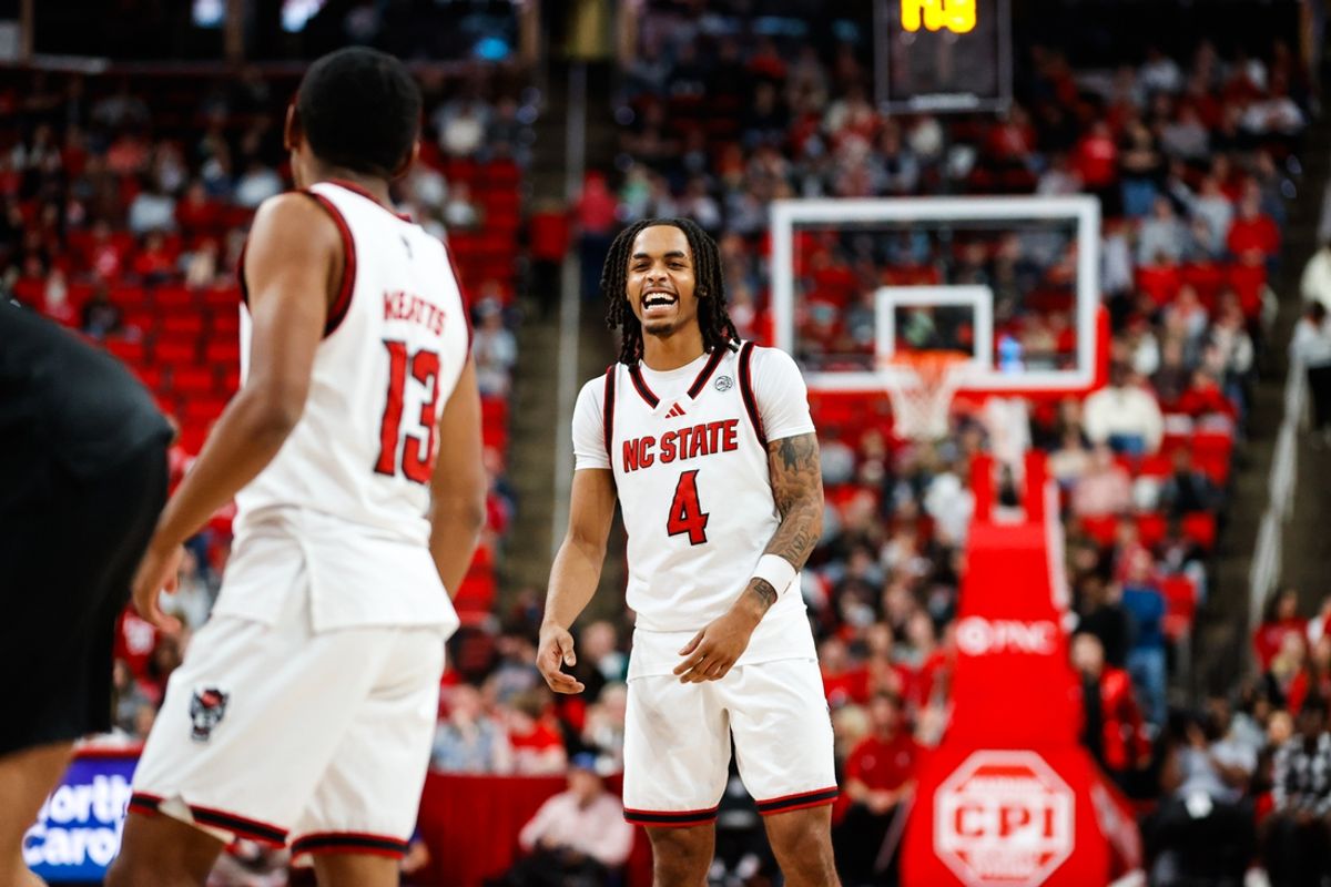 Nov 22, 2024; Raleigh, North Carolina, USA;  North Carolina State Wolfpack guard KJ Keatts (13) is celebrated for his point with guard Breon Pass (4) during the second half of the game against the William & Mary Tribe at Lenovo Center. Mandatory Credit: Jaylynn Nash-Imagn Images