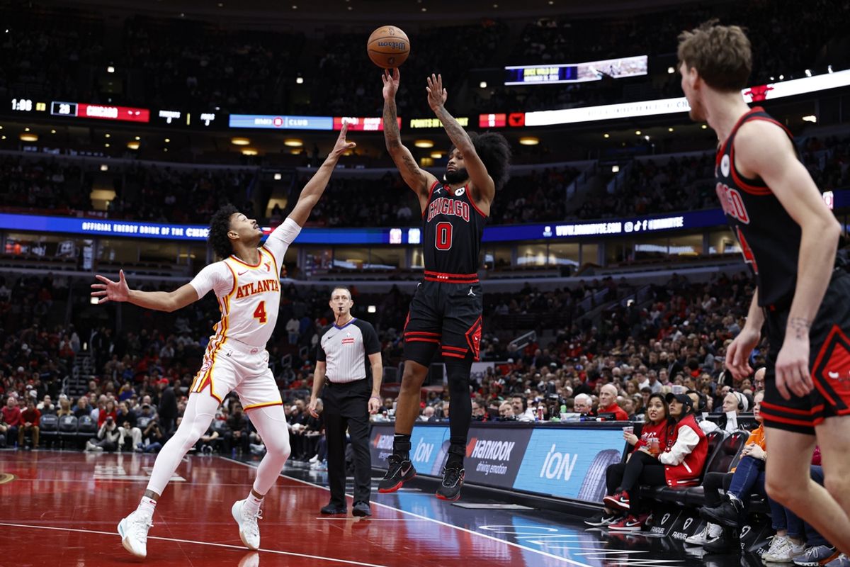 Nov 22, 2024; Chicago, Illinois, USA; Chicago Bulls guard Coby White (0) shoots against Atlanta Hawks guard Kobe Bufkin (4) during the first half at United Center. Mandatory Credit: Kamil Krzaczynski-Imagn Images