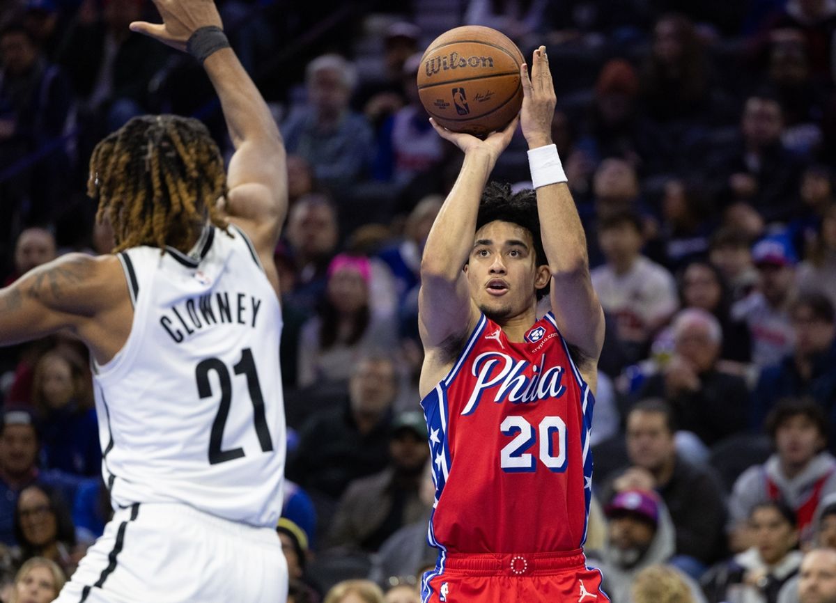 Nov 22, 2024; Philadelphia, Pennsylvania, USA; Philadelphia 76ers guard Jared McCain (20) shoots the ball past Brooklyn Nets forward Noah Clowney (21) during the fourth quarter at Wells Fargo Center. Mandatory Credit: Bill Streicher-Imagn Images