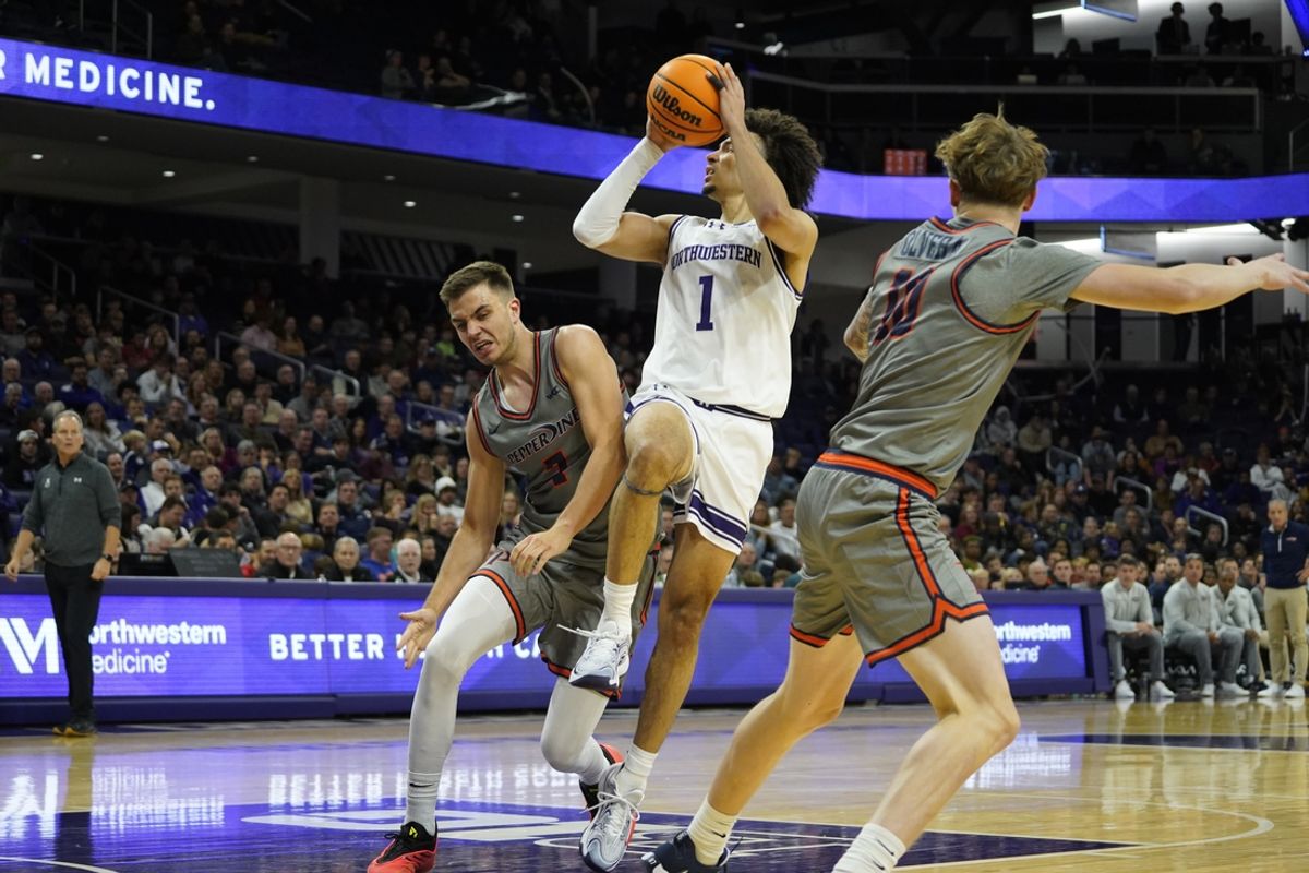 Nov 22, 2024; Evanston, Illinois, USA; Pepperdine Waves forward Stefan Todorovic (7) defends Northwestern Wildcats guard Jalen Leach (1) during the second half at Welsh-Ryan Arena. Mandatory Credit: David Banks-Imagn Images