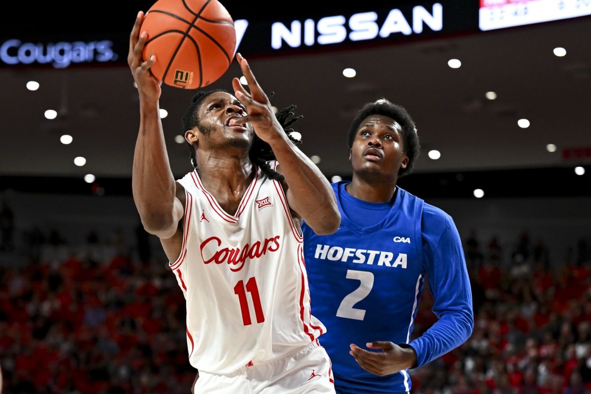Nov 22, 2024; Houston, Texas, USA; Houston Cougars forward Joseph Tugler (11) drives to the basket as Hofstra Pride guard Jaquan Sanders (2) defends during the second half at Fertitta Center. Mandatory Credit: Maria Lysaker-Imagn Images