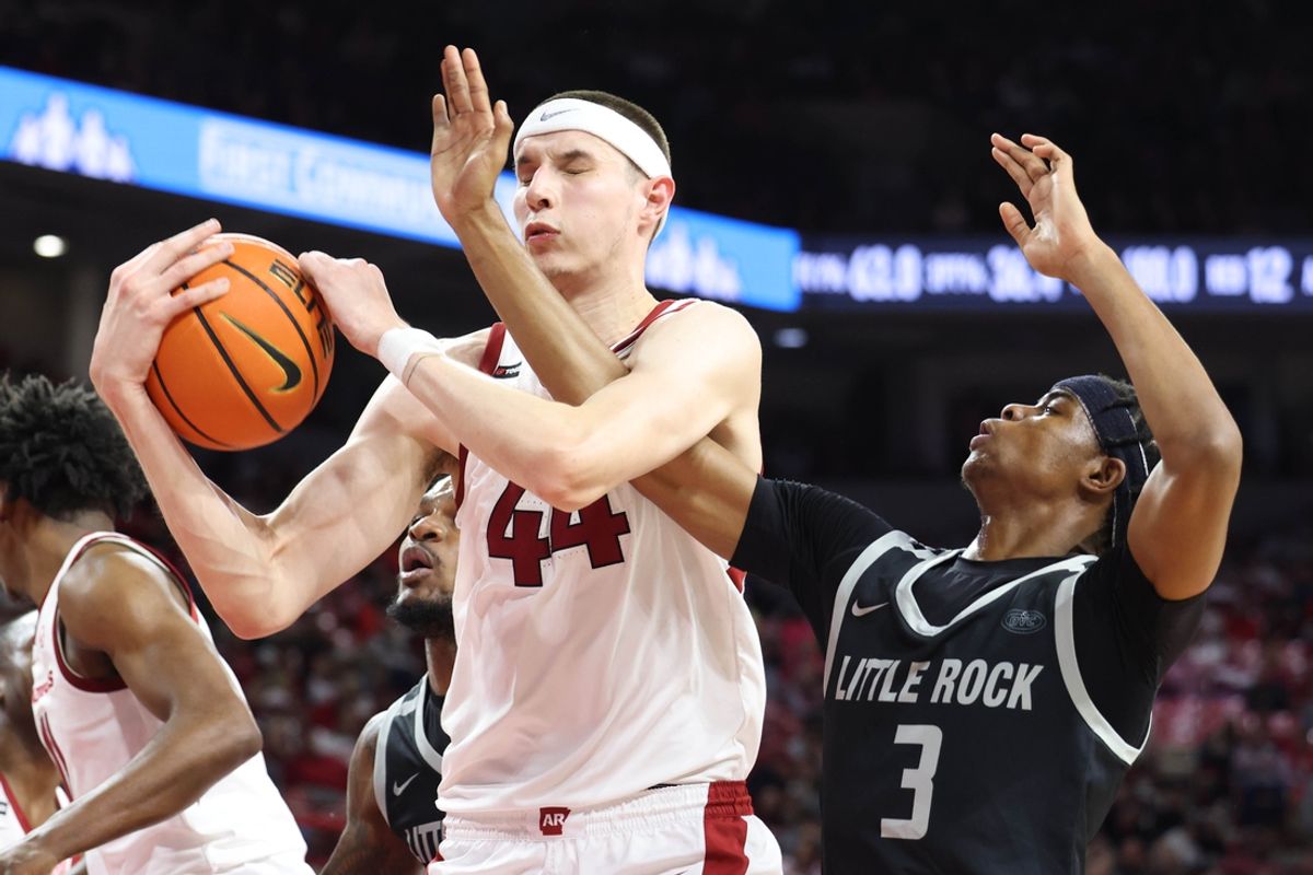 Nov 22, 2024; Fayetteville, Arkansas, USA; Arkansas Razorbacks forward Zvonimir Ivisic (44) grabs a rebound from Little Rock Trojans guard Isaiah Lewis (3) during the first half at Bud Walton Arena. Mandatory Credit: Nelson Chenault-Imagn Images