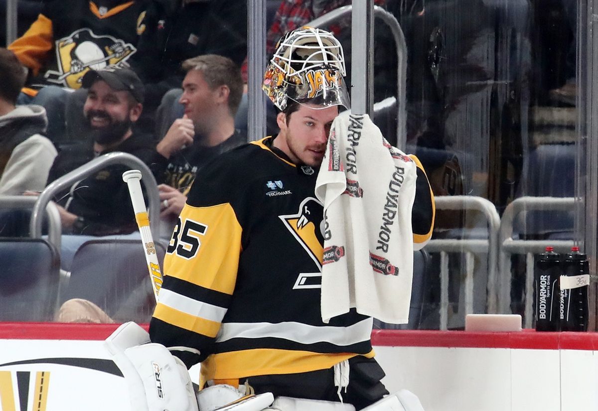 Nov 22, 2024; Pittsburgh, Pennsylvania, USA; Pittsburgh Penguins goaltender Tristan Jarry (35) wipes his face during a time-out against the Winnipeg Jets in the third period at PPG Paints Arena. Mandatory Credit: Charles LeClaire-Imagn Images
