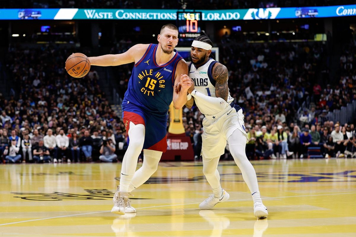 Nov 22, 2024; Denver, Colorado, USA; Denver Nuggets center Nikola Jokic (15) controls the ball under pressure from Dallas Mavericks guard Jaden Hardy (1) in the first quarter at Ball Arena. Mandatory Credit: Isaiah J. Downing-Imagn Images