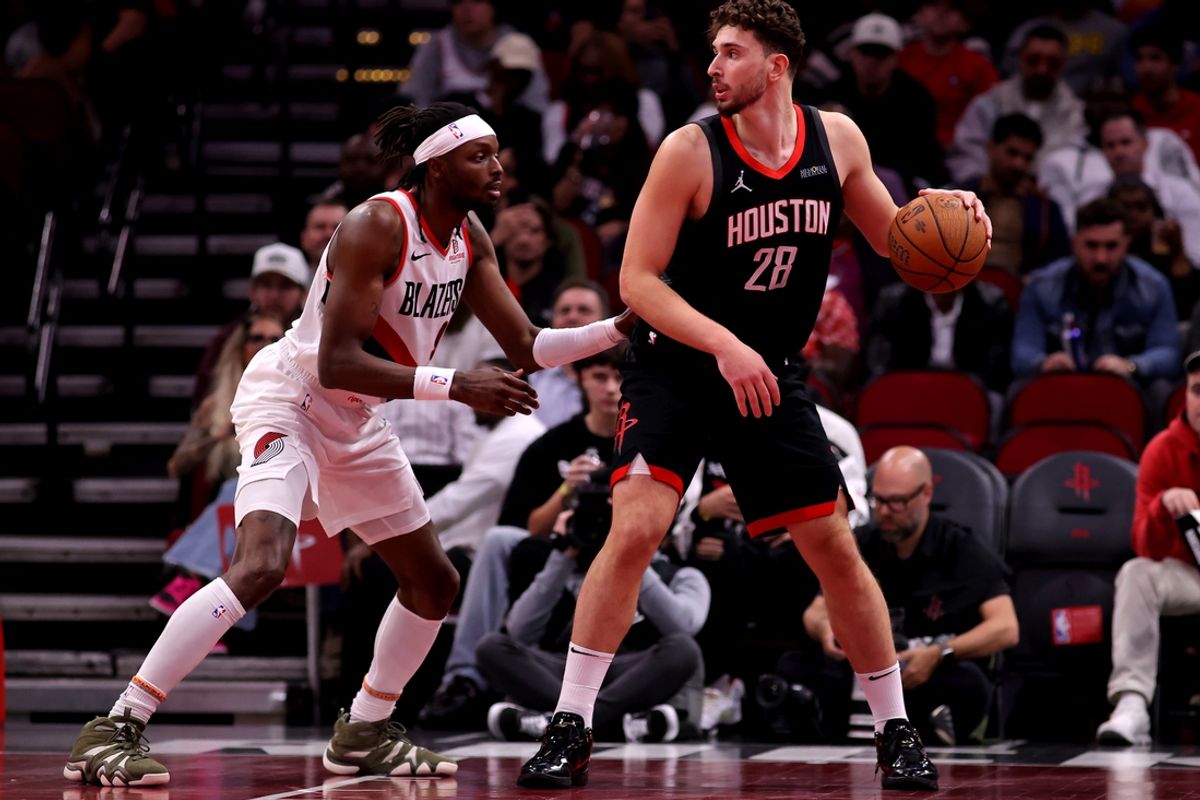Nov 22, 2024; Houston, Texas, USA; Houston Rockets center Alperen Sengun (28) handles the ball against Portland Trail Blazers forward Jerami Grant (9) during the third quarter at Toyota Center. Mandatory Credit: Erik Williams-Imagn Images