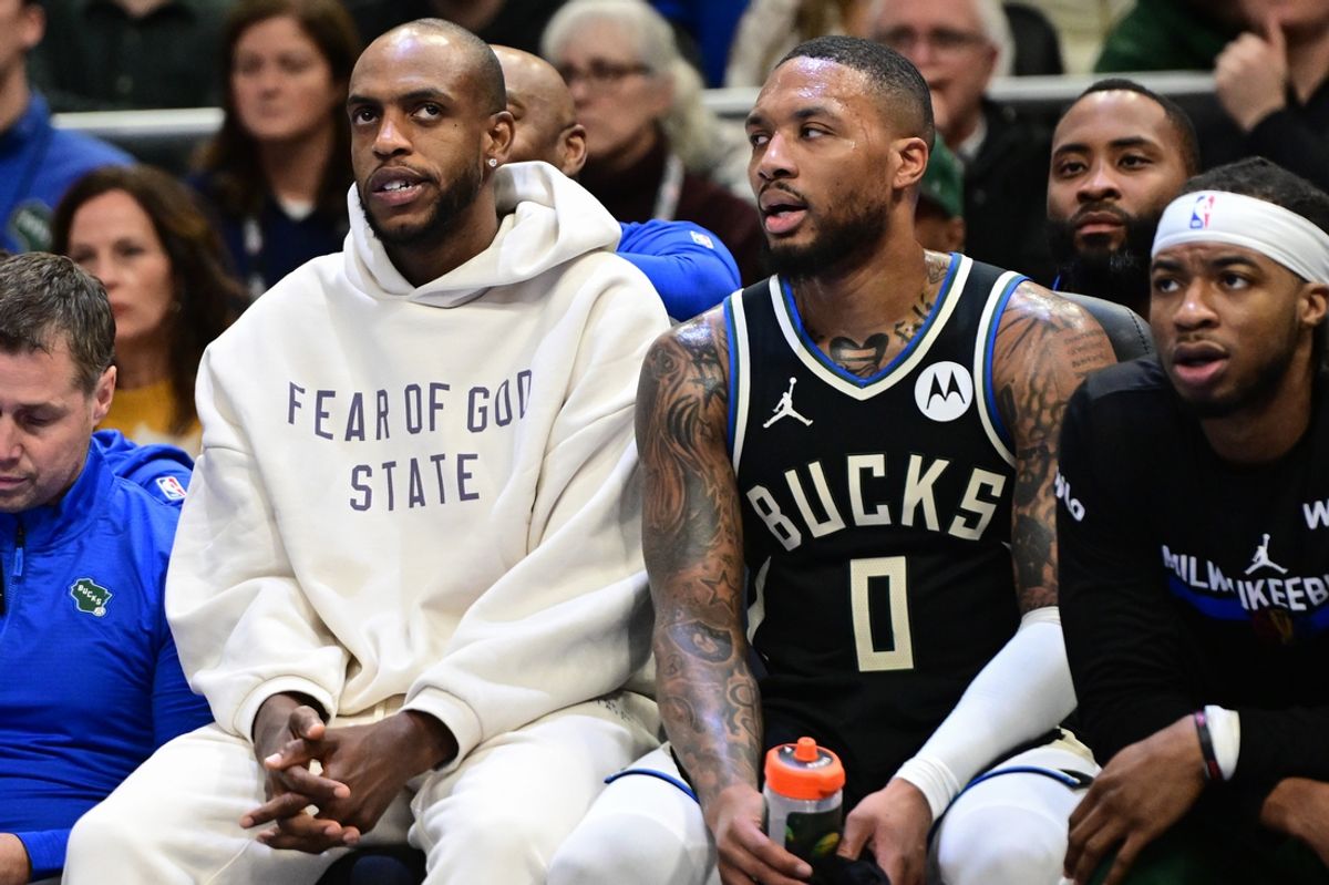 Nov 22, 2024; Milwaukee, Wisconsin, USA; Milwaukee Bucks forward Khris Middleton (left) sits on the bench with  guard Damian Lillard (0) in the second quarter against the Indiana Pacers at Fiserv Forum. Mandatory Credit: Benny Sieu-Imagn Images