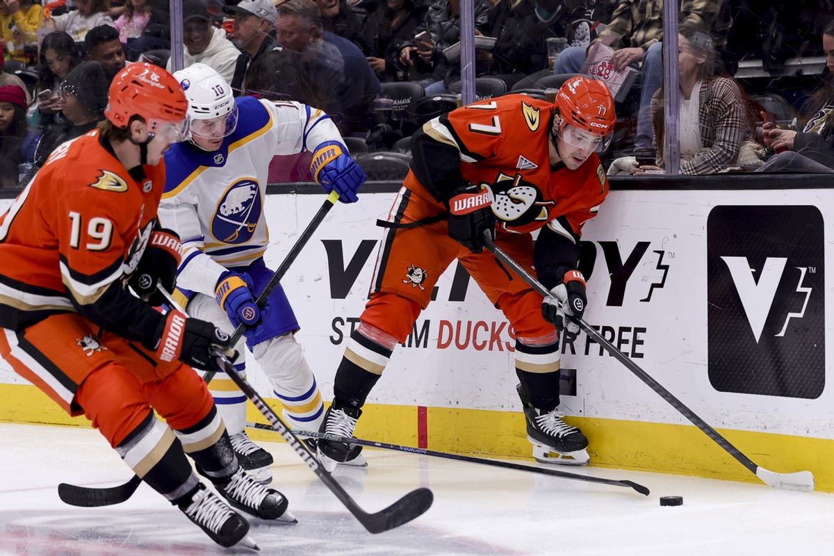 Nov 22, 2024; Anaheim, California, USA; Anaheim Ducks right wing Frank Vatrano (77) and right wing Troy Terry (19) vie for the puck against Buffalo Sabres defenseman Henri Jokiharju (10) during the second period at Honda Center. Mandatory Credit: Ryan Sun-Imagn Images
