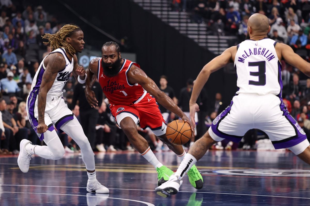 Nov 22, 2024; Inglewood, California, USA;  Los Angeles Clippers guard James Harden (1) dribbles the ball between Sacramento Kings guard Keon Ellis (23) and guard Jordan McLaughlin (3) during the first quarter at Intuit Dome. Mandatory Credit: Kiyoshi Mio-Imagn Images