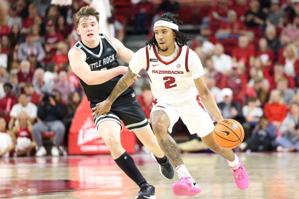 Nov 22, 2024; Fayetteville, Arkansas, USA; Arkansas Razorbacks guard Boogie Fland (2) drives against Little Rock Trojans guard Christian Hughes (0) during the second half at Bud Walton Arena. Arkansas won 79-67. Mandatory Credit: Nelson Chenault-Imagn Images